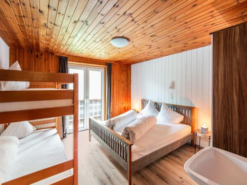 a bedroom with two bunk beds and a sink at Holiday home in the Silvretta-Montafon ski area in Sankt Gallenkirch