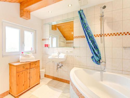 a bathroom with a tub and a sink at Holiday home in the Silvretta-Montafon ski area in Sankt Gallenkirch