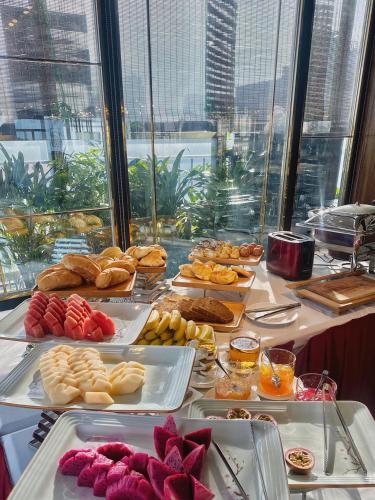 a table with many different types of food on it at The Chi Boutique Hotel in Hanoi
