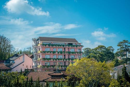a large brick building with a lot of windows at Brick House Dalat Hotel in Da Lat