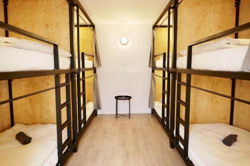 a room with four bunk beds in a hostel at Schöndorf Hostel - virtual reception in Bratislava