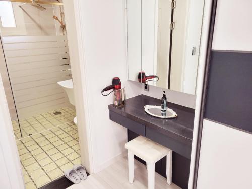 a bathroom with a sink and a mirror at Stay by J in Jeju