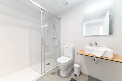 a bathroom with a shower and a toilet and a sink at Casa Catalina - breathtaking sea views by OYOOSTAYS in Dehesa de Campoamor