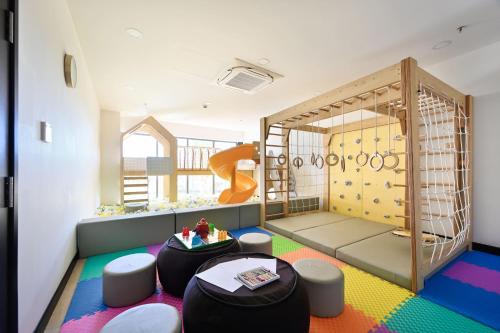 a room with a play room with a slide at Emerald Ho Tram Resort in Ho Tram