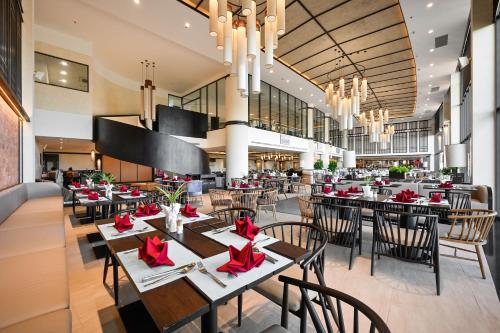 a restaurant with tables and chairs with red bows at Emerald Ho Tram Resort in Ho Tram