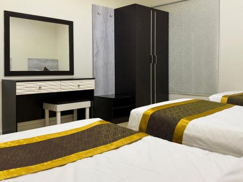 a hotel room with two beds and a mirror at فندق آبل Apple Hotel in Riyadh