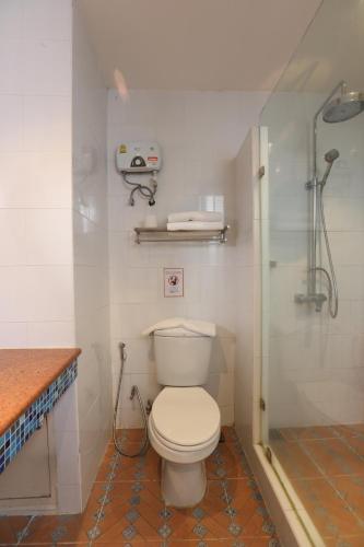a bathroom with a toilet and a shower at Studio F Sukhumvit in Bangkok