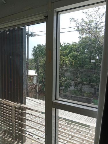 une fenêtre ouverte avec vue sur un balcon dans l'établissement ISI Backpackers', à Mae Sot