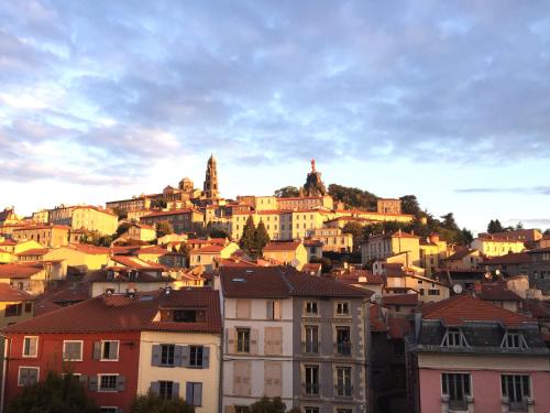 a group of buildings on top of a hill at ibis budget Le Puy En Velay in Le Puy en Velay