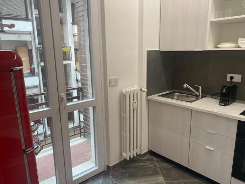 a small kitchen with a sink and a radiator at APPARTAMENTO GIORGIO in Varese