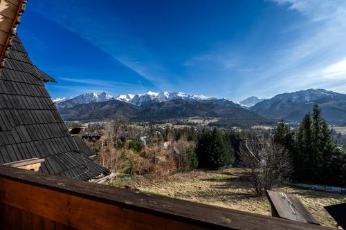a view of the mountains from the deck of a house at Osada Kościelisko - Tatry na Wyciągnięcie Ręki in Kościelisko