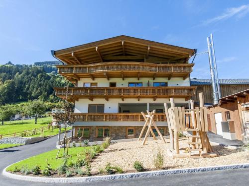 a building with a playground in front of it at Farmhouse in Schwendau with Ski Storage in Hippach