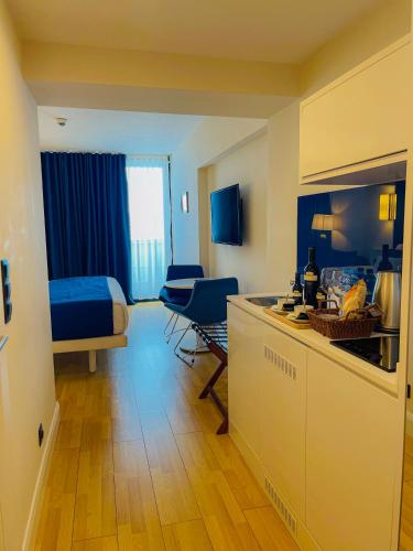 a room with a kitchen and a living room at Batumi High View in Batumi