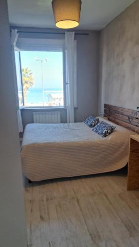 a bedroom with a large bed with a large window at Affittacamere Happy in Porto SantʼElpidio