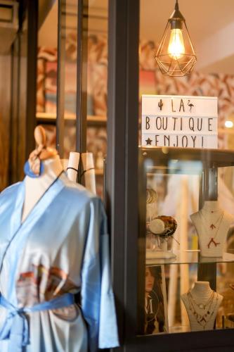 a shop window with a shirt and a sign at Le Saint Erasme, Hotel Eco Friendly in Calvi