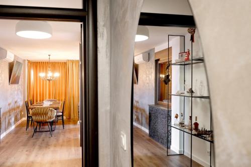 a living room with a table and a dining room at Sunčica in Velika Gorica