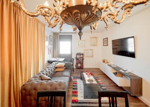 - un salon avec un canapé et un lustre dans l'établissement Sunčica, à Velika Gorica
