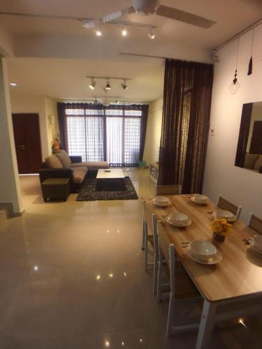 a large living room with a table and a couch at 38 Georgetown 3 Storey Terrace local food 5rooms 16pax in George Town