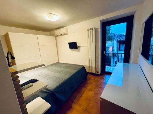 Kleines Zimmer mit einem Bett und einem Balkon. in der Unterkunft Casa Nora in Manerba del Garda