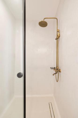 a shower with a glass door in a bathroom at Zannos Luxury Suites By Zannos Collection in Pirgos