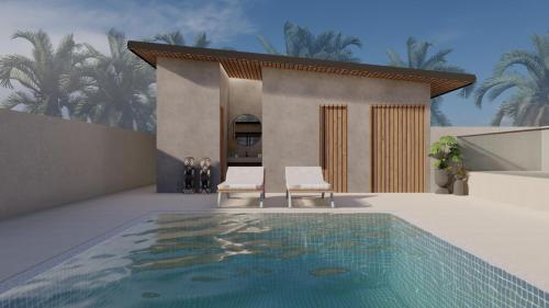 uma casa com duas cadeiras e uma piscina em Hotel Namah Courtyard em Khāpri