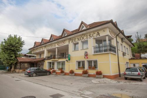 a large yellow building with a sign on it at GOSTILNA IN PIZZERIA KOVAČ in Litija