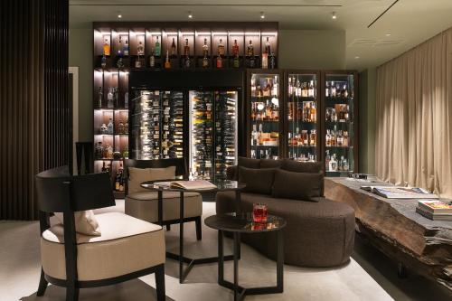 a wine tasting room with a couch and chairs at Le Cattedrali Relais by Laqua Collection in Asti