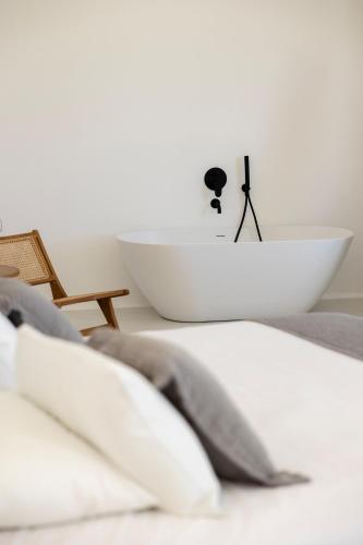 a white bowl and a sink in a bedroom at Zannos Luxury Suites By Zannos Collection in Pirgos