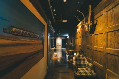 a train station with two chairs and a train at SWIIO Hotel Ximending in Taipei