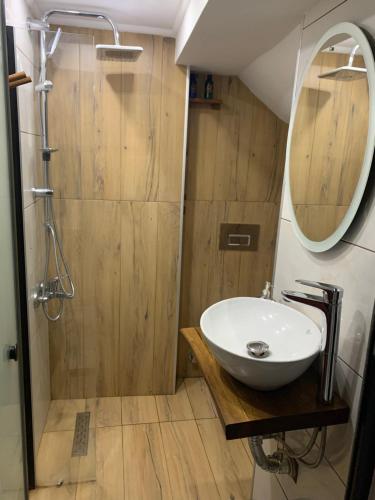 a bathroom with a sink and a shower with a mirror at Valeria House in Istanbul