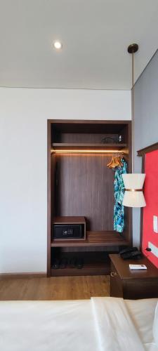 a living room with a bed and a tv at Bstudio in APEC Mandala Mũi Né in Phan Thiet