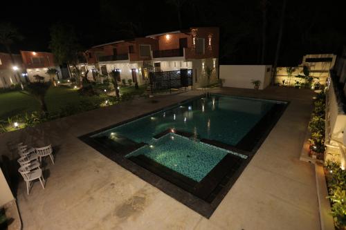 een uitzicht op een zwembad in de nacht bij PALM PARADISE Beach Resort in Pondicherry