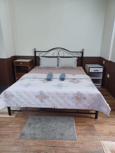 a bedroom with a bed with two pillows at Iartong Guest House in Mawlynnong