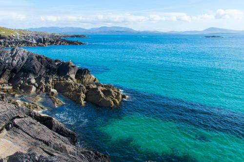 an aerial view of the ocean near a rocky shore at Reeks Country House in Killarney