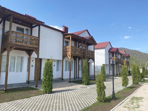 a row of houses with balconies on a street at Motives Inn Dilijan in Dilijan