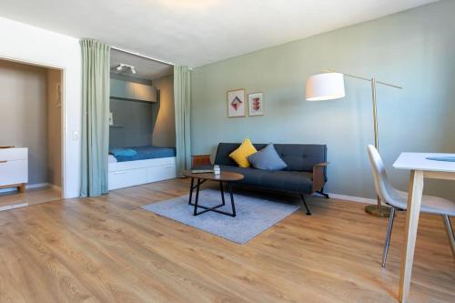een woonkamer met een bank en een tafel bij City Apartment mit Sonnenbalkon in Wuppertal