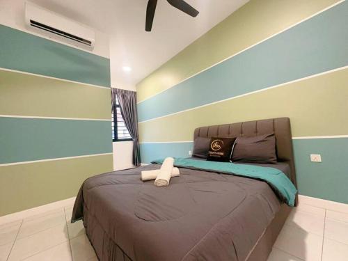 a bedroom with a large bed with blue and green stripes at A18 Tebing Dato Onn 39 in Johor Bahru