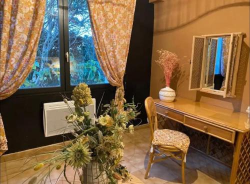 a room with a desk and a chair and a window at Gîte de Kim in Ferques