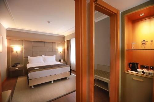 a hotel room with a bed and a bathroom at La Quinta by Wyndham Giresun in Giresun