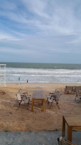 a group of chairs and a table on the beach at Bstudio in APEC Mandala Mũi Né in Phan Thiet