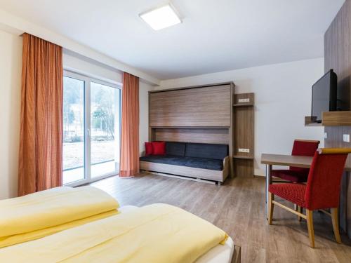 クライナルにあるApartment in Kleinarl near Ski Area with Balcony Parkingのベッド、デスク、デスクが備わる客室です。