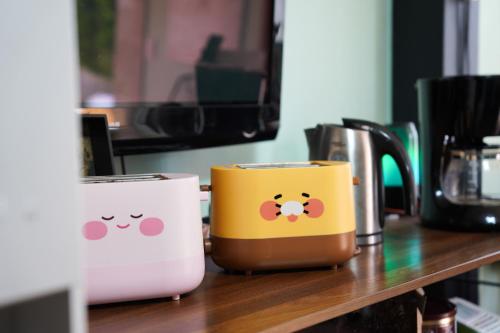 two coffee cups with hello kitty faces on a counter at ttottot Jeju Backpackers in Seogwipo