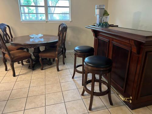 a dining room with a table and chairs at The Peacock Cottage in San Marcos