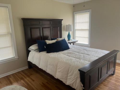 a bedroom with a large bed with blue pillows at The Peacock Cottage in San Marcos