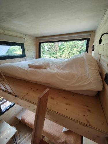 a bed in the middle of a tiny house at Moose home Tiny house AMBUR in Saint-Jacques-dʼAmbur
