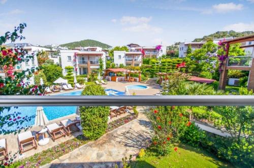 a view from the balcony of a resort with a swimming pool at Dibek Homes Villa & Hotel in Yalıkavak