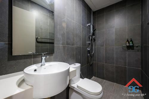 a bathroom with a white sink and a toilet at Astoria Ampang By Grabstay in Kuala Lumpur