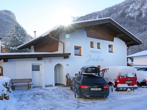 a car parked in front of a building in the snow at Cosy holiday home in L ngenfeld in Längenfeld