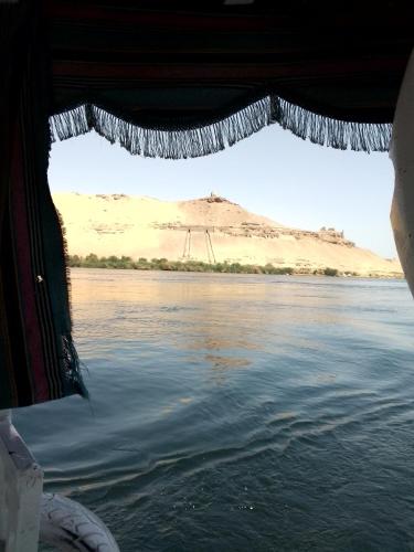 a view from the window of a boat on a body of water at Ozzy Tourism in Aswan