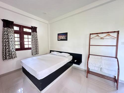 a bedroom with a bed and a ladder in it at Jungle Fence in Bentota